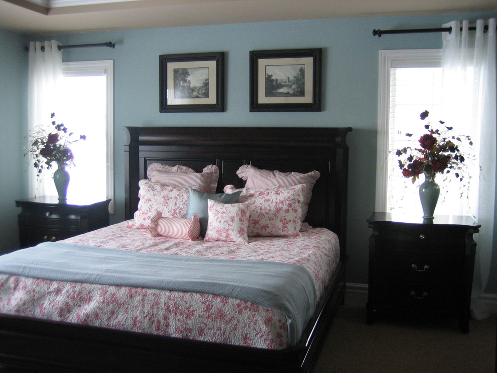 Inspiration for a mid-sized timeless master bedroom remodel in Milwaukee with blue walls and no fireplace