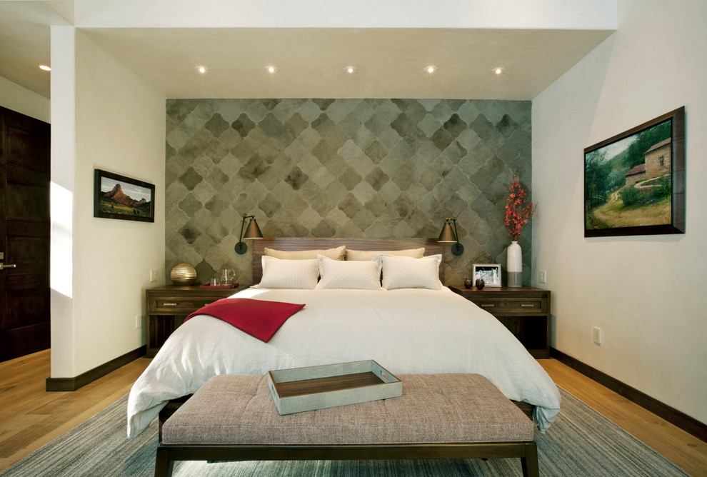Photo of a rustic master bedroom in Denver with beige walls and medium hardwood flooring.