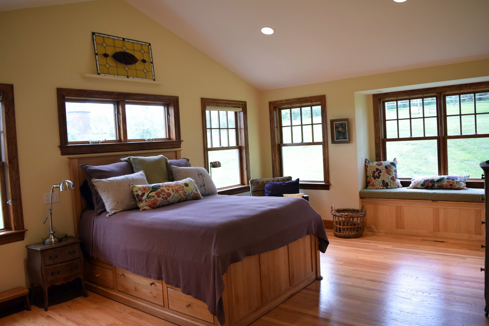 Inspiration for a mid-sized master bedroom remodel in Boston with yellow walls