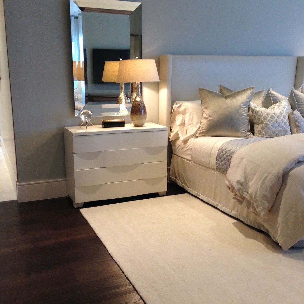 This is an example of a large contemporary master bedroom in Miami with grey walls and dark hardwood flooring.