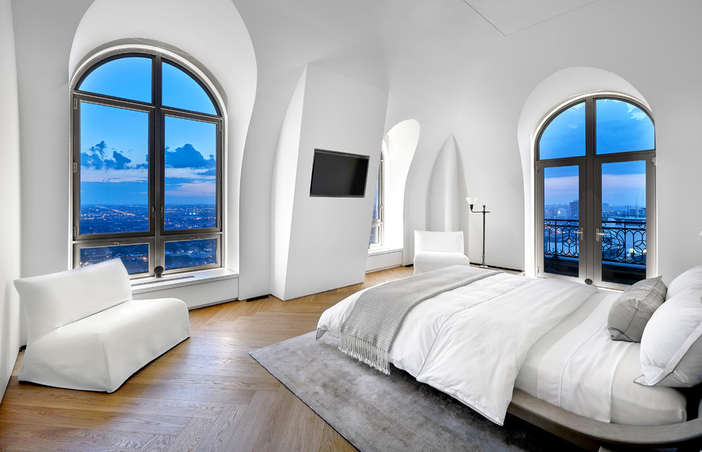 Inspiration for a medium sized contemporary master bedroom in Chicago with white walls and light hardwood flooring.