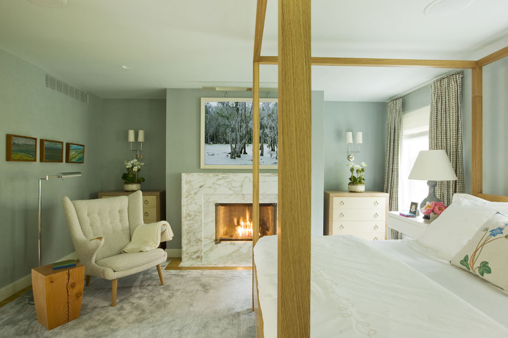 Bedroom - contemporary master bedroom idea in New York with blue walls and a standard fireplace