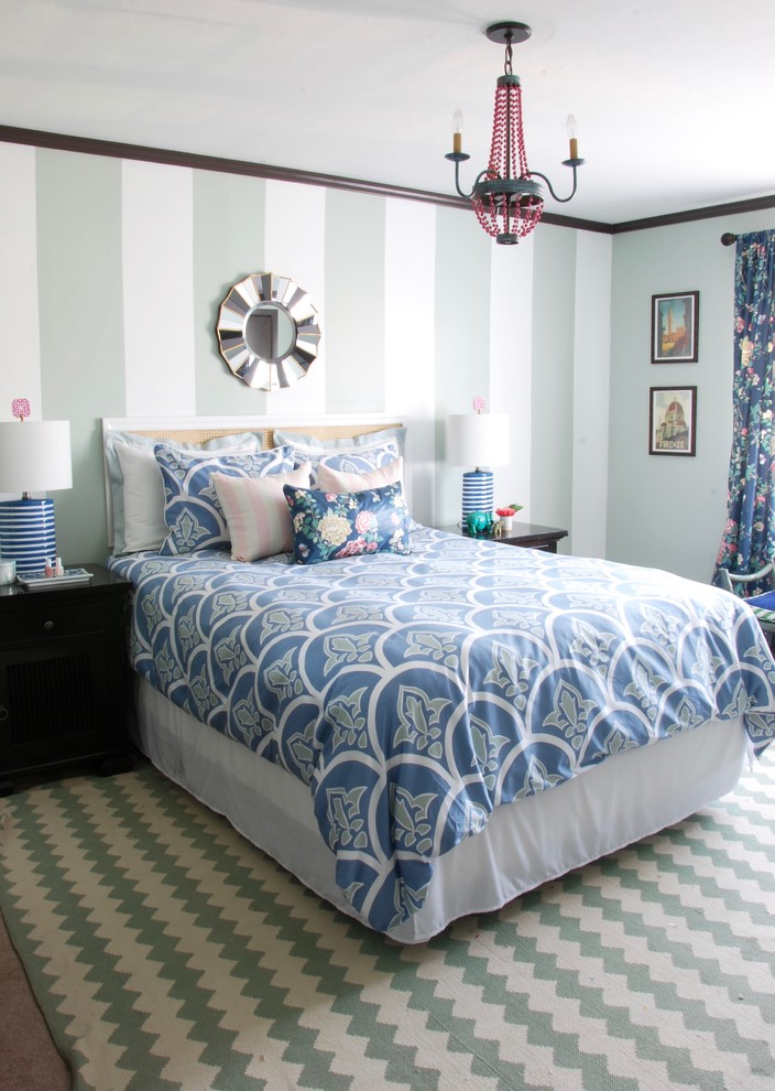 Medium sized traditional master bedroom in New York with blue walls, carpet and beige floors.