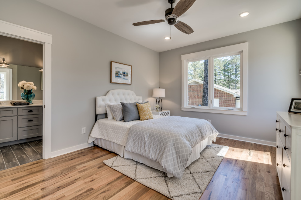 Bedroom - transitional master light wood floor and beige floor bedroom idea in Raleigh with gray walls