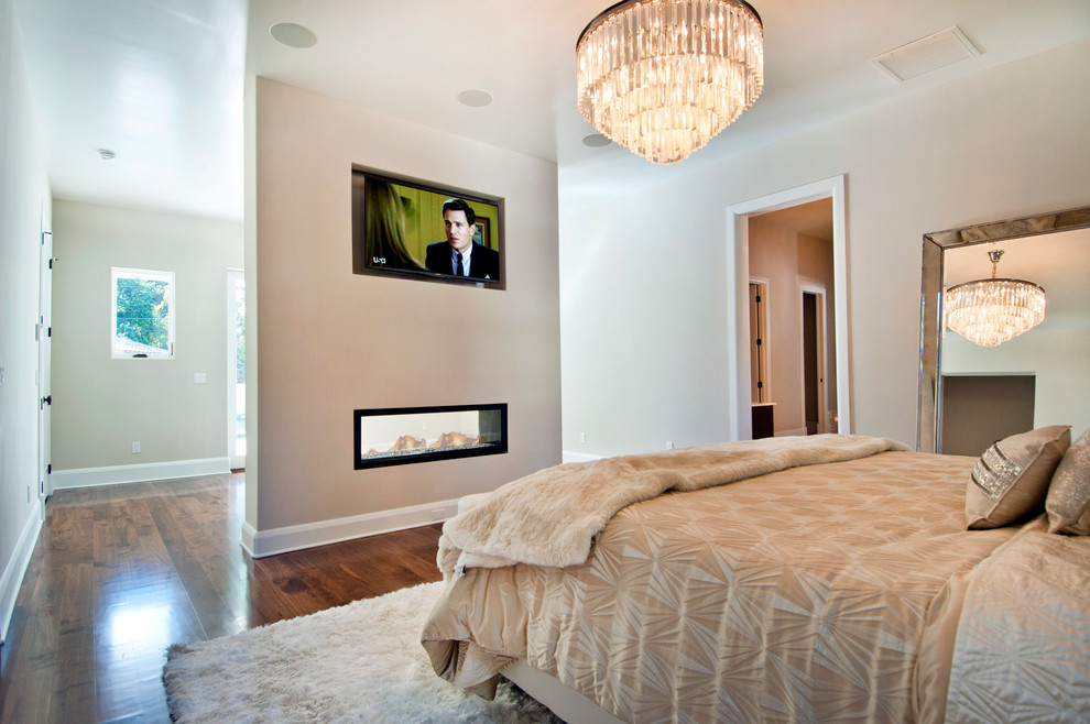 Mid-sized transitional master medium tone wood floor bedroom photo in Tampa with beige walls and a ribbon fireplace