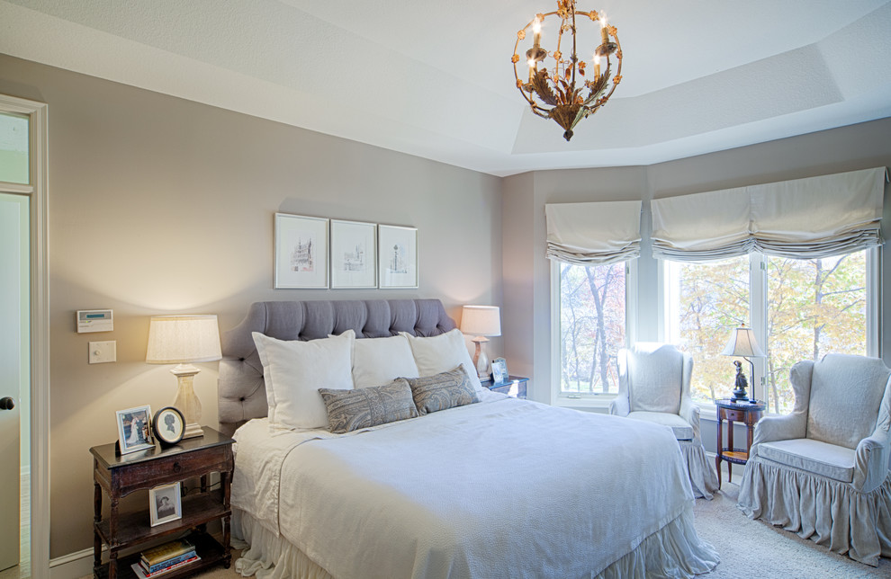 Photo of a traditional master bedroom in Minneapolis with grey walls.