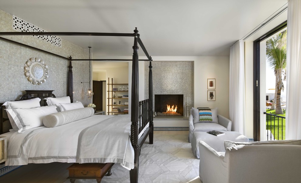 Island style bedroom photo in Mexico City with a tile fireplace and a standard fireplace