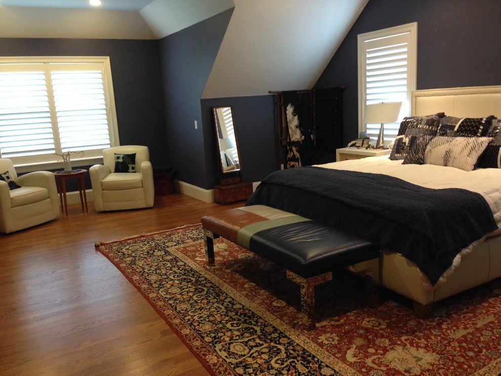 This is an example of a large world-inspired bedroom in Boston with blue walls and medium hardwood flooring.