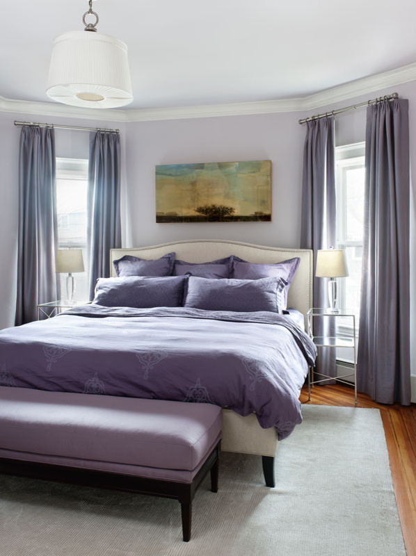 Example of a trendy master medium tone wood floor bedroom design in Boston with purple walls