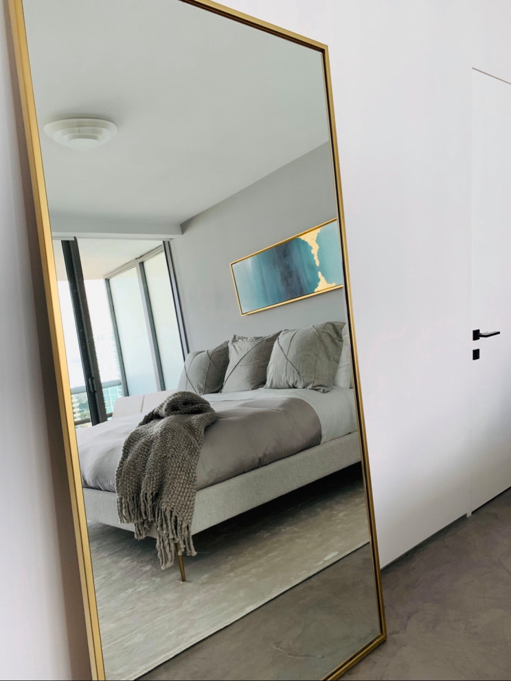Photo of a medium sized modern master bedroom in Miami with white walls, concrete flooring and grey floors.