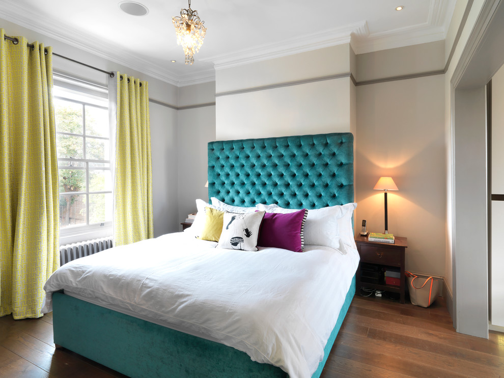 Photo of a medium sized eclectic master bedroom in London with grey walls and dark hardwood flooring.