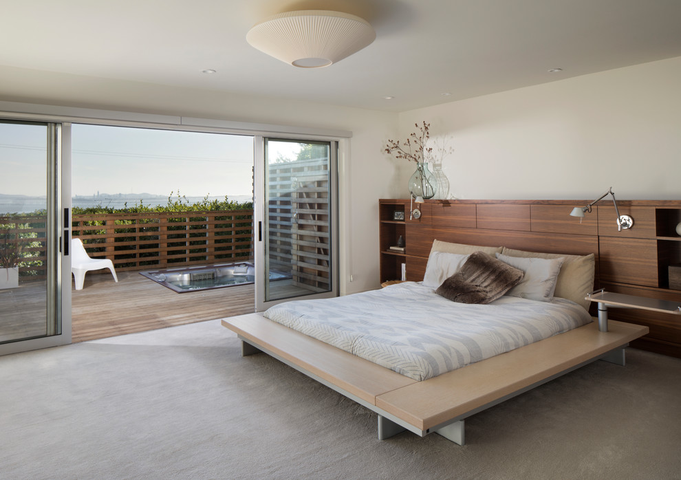 Photo of a medium sized contemporary master bedroom in San Francisco with white walls, carpet and beige floors.
