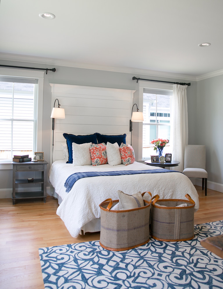 Mid-sized transitional master light wood floor bedroom photo in Portland Maine with gray walls