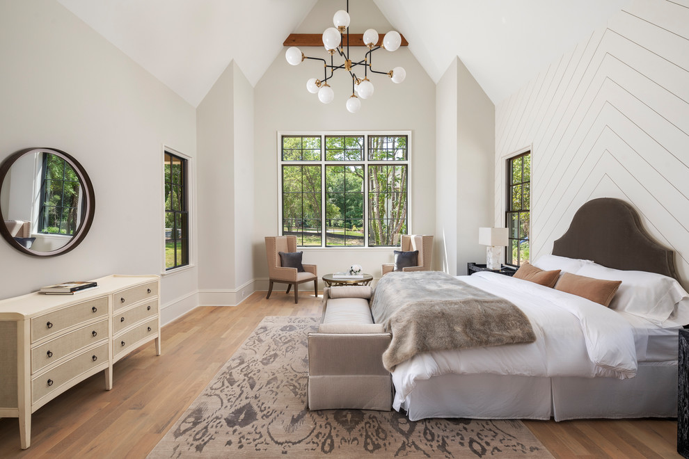 Large eclectic master medium tone wood floor bedroom photo in Charlotte with beige walls