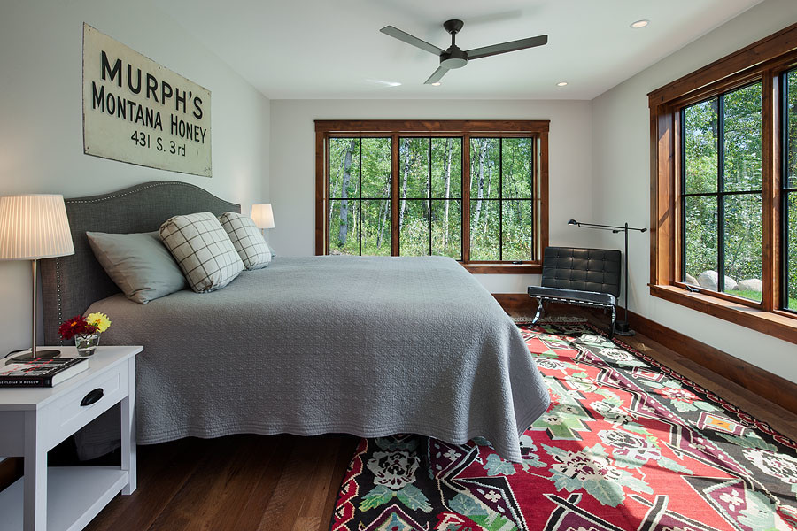 Example of a mid-sized transitional master medium tone wood floor and brown floor bedroom design in Other with white walls
