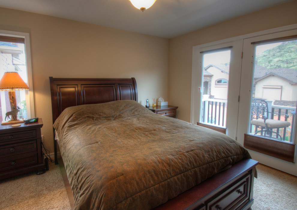 This is an example of a medium sized traditional master bedroom in Denver with beige walls, carpet and no fireplace.