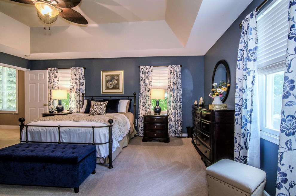 Large classic master bedroom in Philadelphia with blue walls, carpet, no fireplace and beige floors.