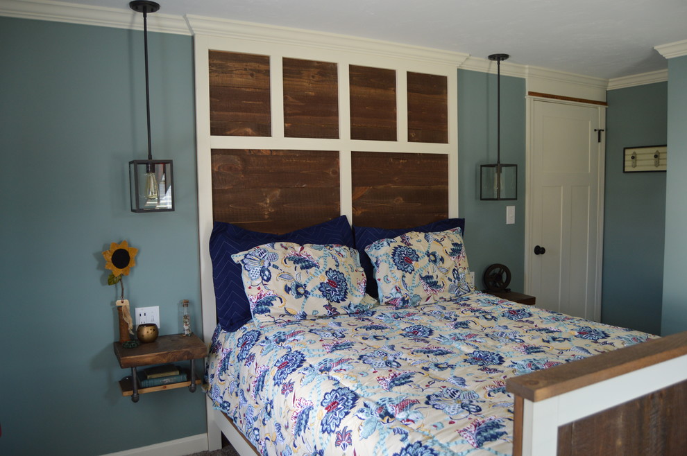 This is an example of a medium sized industrial master bedroom in Boston with blue walls, carpet and no fireplace.