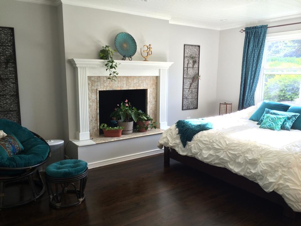 Example of a large trendy master dark wood floor bedroom design in Chicago with gray walls, a standard fireplace and a tile fireplace