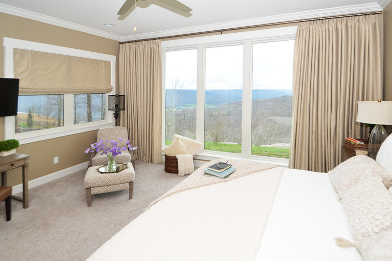 Large classic master bedroom in Other with beige walls, carpet and beige floors.