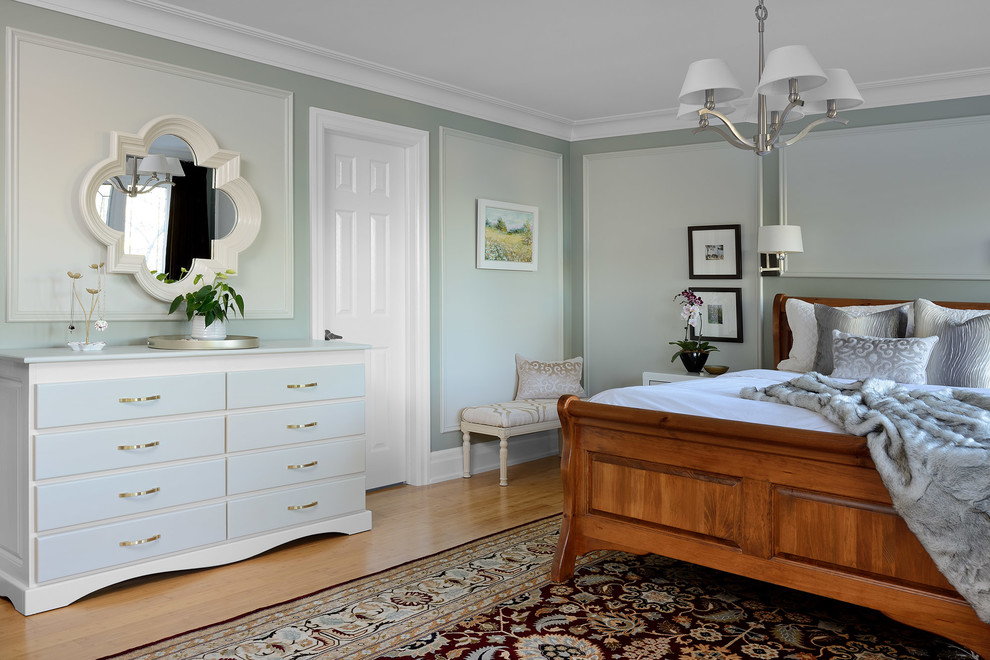 Inspiration for a large traditional master bedroom in Toronto with green walls, bamboo flooring and brown floors.