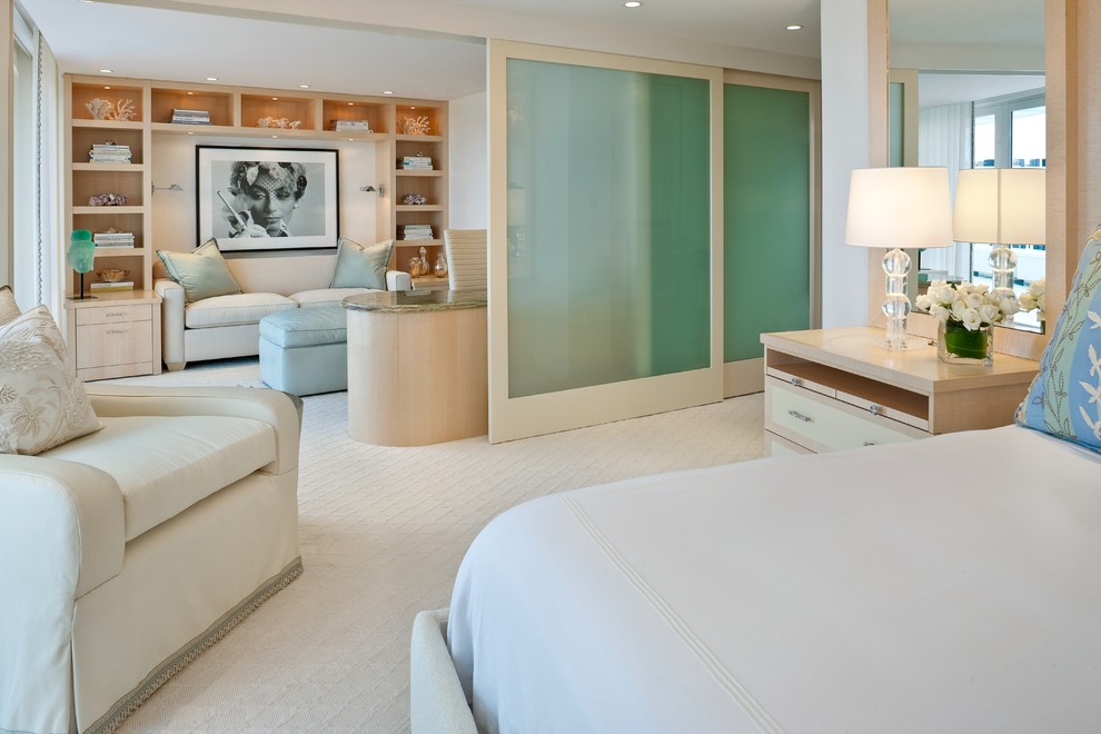 Contemporary master bedroom in Miami with carpet.