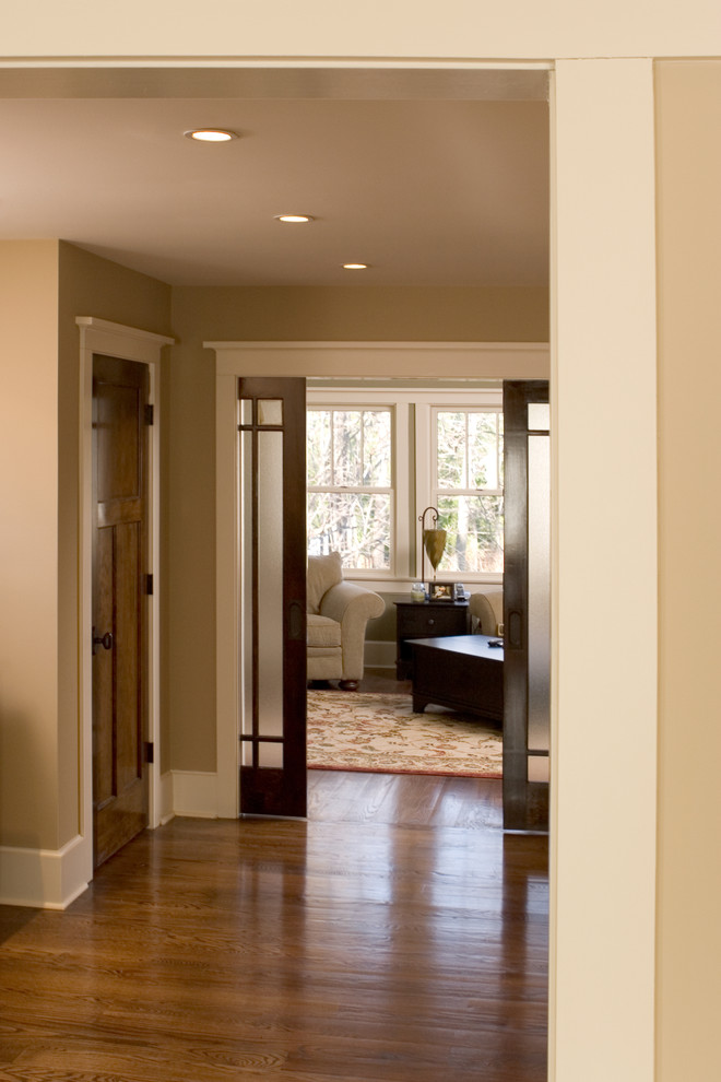 Photo of a large traditional master bedroom in New York with beige walls and medium hardwood flooring.