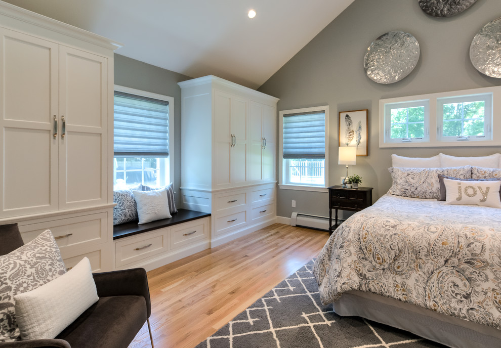 Mid-sized elegant master medium tone wood floor and brown floor bedroom photo in Boston with gray walls and no fireplace