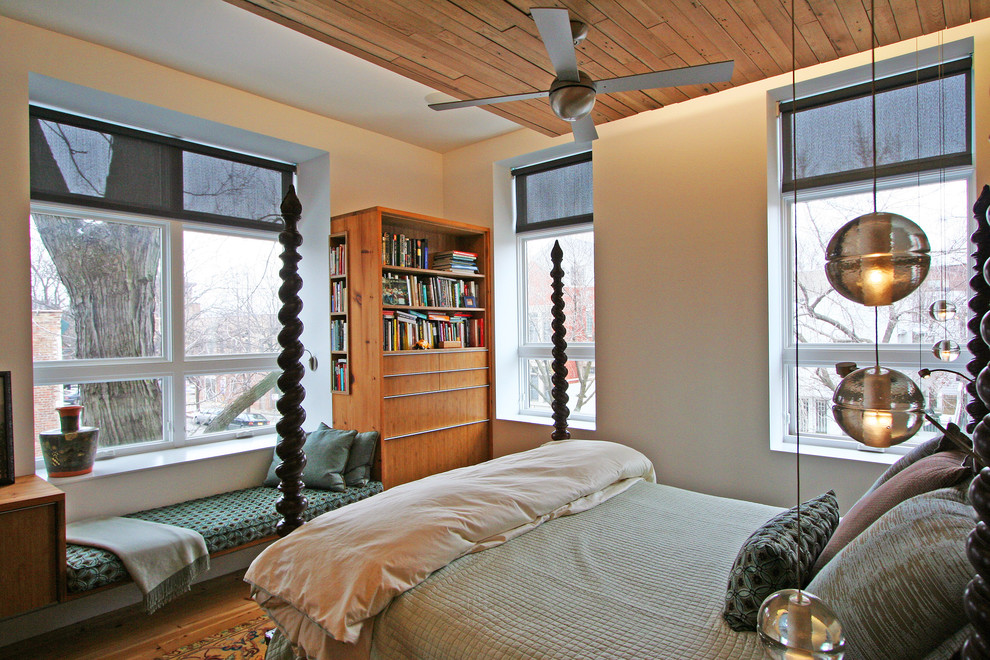 This is an example of a contemporary master bedroom in Chicago with beige walls.
