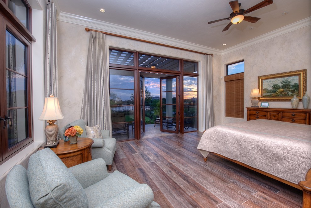 Photo of a traditional master bedroom in Tampa with beige walls, dark hardwood flooring and no fireplace.