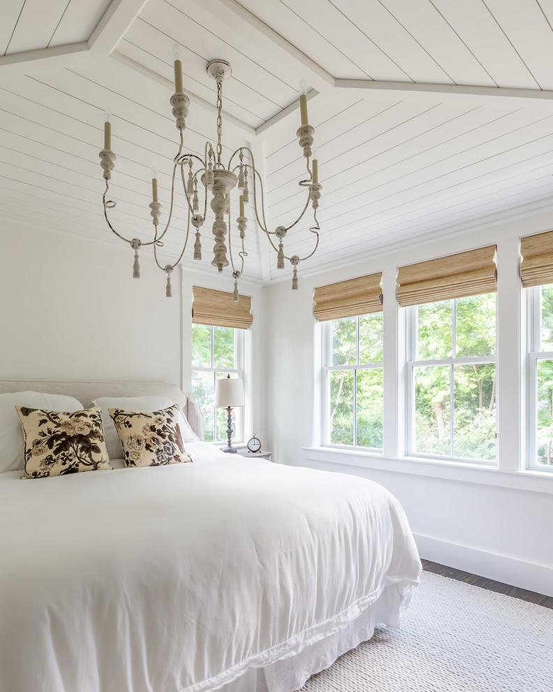 This is an example of a large nautical master bedroom in Boston with white walls, dark hardwood flooring, a timber clad ceiling, a standard fireplace and a tiled fireplace surround.