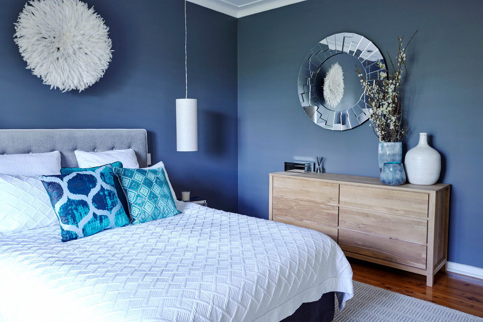 Design ideas for a medium sized contemporary master bedroom in Sydney with grey walls and medium hardwood flooring.