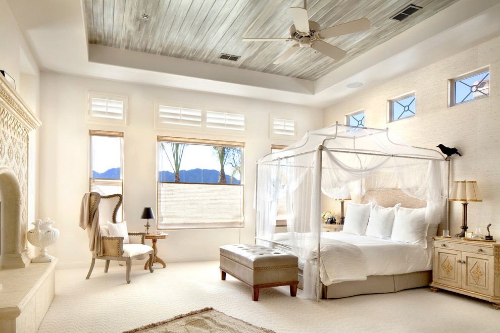 Imagen de dormitorio mediterráneo con paredes beige, moqueta, todas las chimeneas y suelo beige