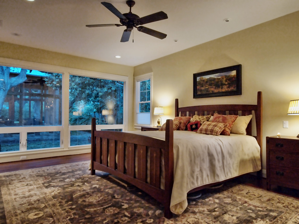 Bedroom - mid-sized craftsman medium tone wood floor bedroom idea in Austin with yellow walls