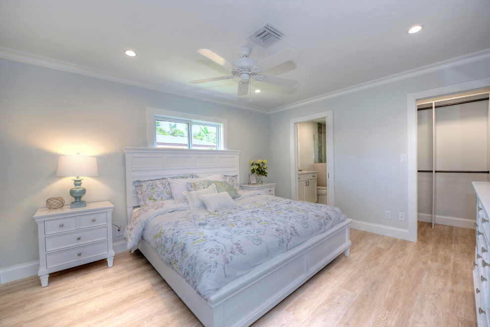Photo of a beach style bedroom in Miami with light hardwood flooring.