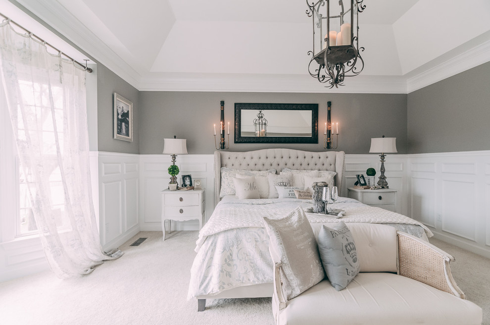 Large vintage master bedroom in Nashville with grey walls and carpet.