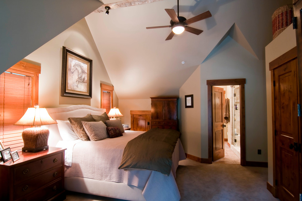 Example of a small mountain style carpeted bedroom design in Denver with beige walls