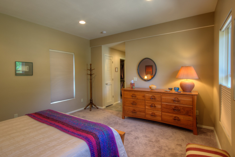 Example of a large classic master carpeted bedroom design in Denver with beige walls