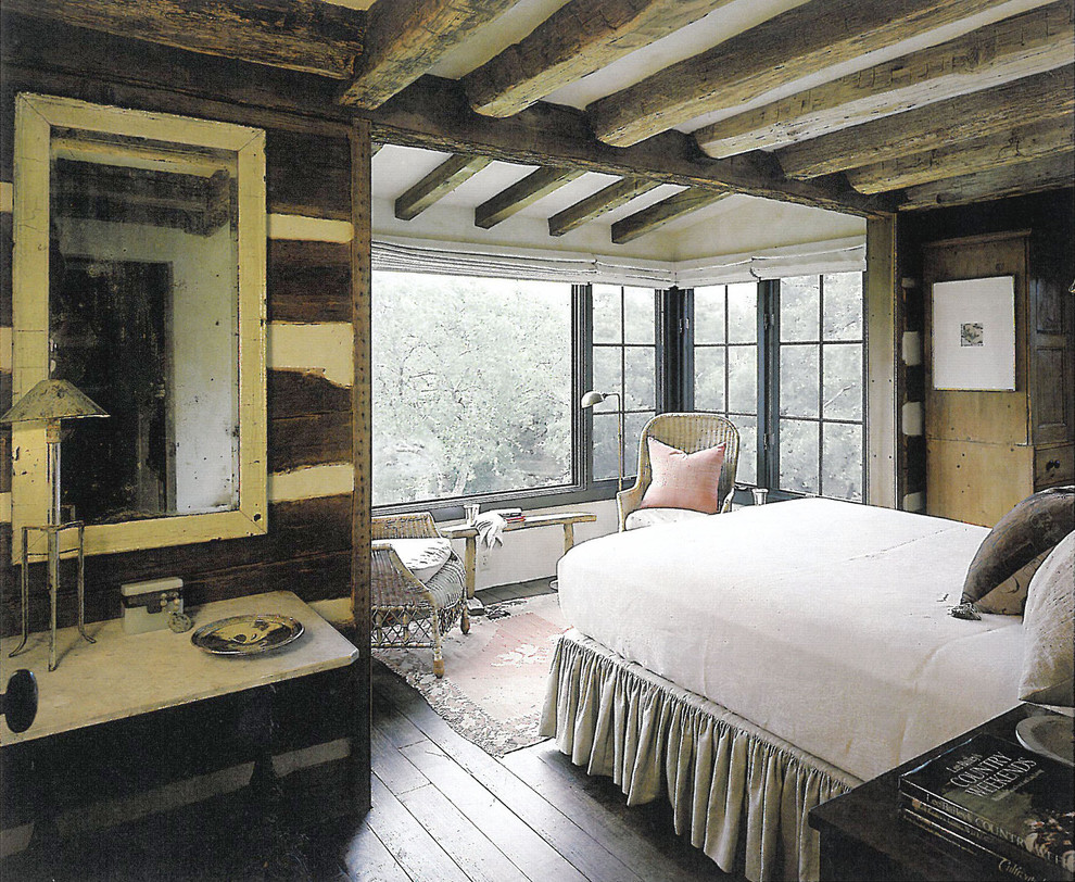 Design ideas for a medium sized rustic master bedroom in Austin with dark hardwood flooring.
