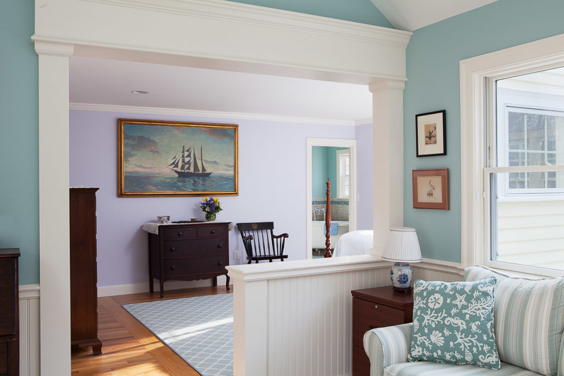 Example of a classic master medium tone wood floor bedroom design in Boston