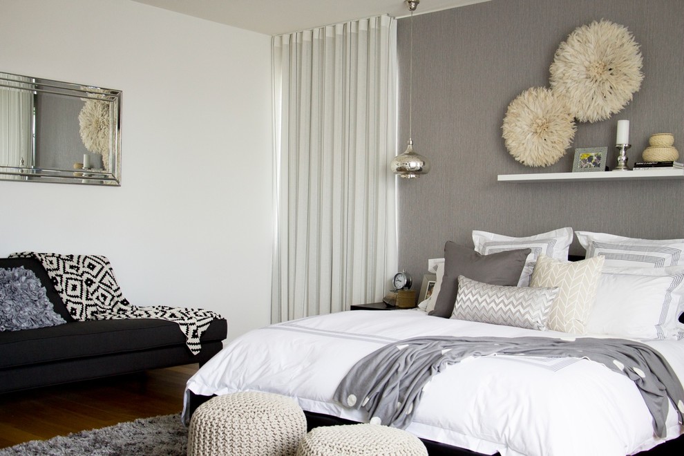 Design ideas for a large contemporary master bedroom in Gold Coast - Tweed with white walls and light hardwood flooring.