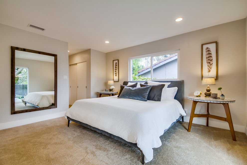 Large mid-century modern master carpeted bedroom photo in San Diego with gray walls and no fireplace