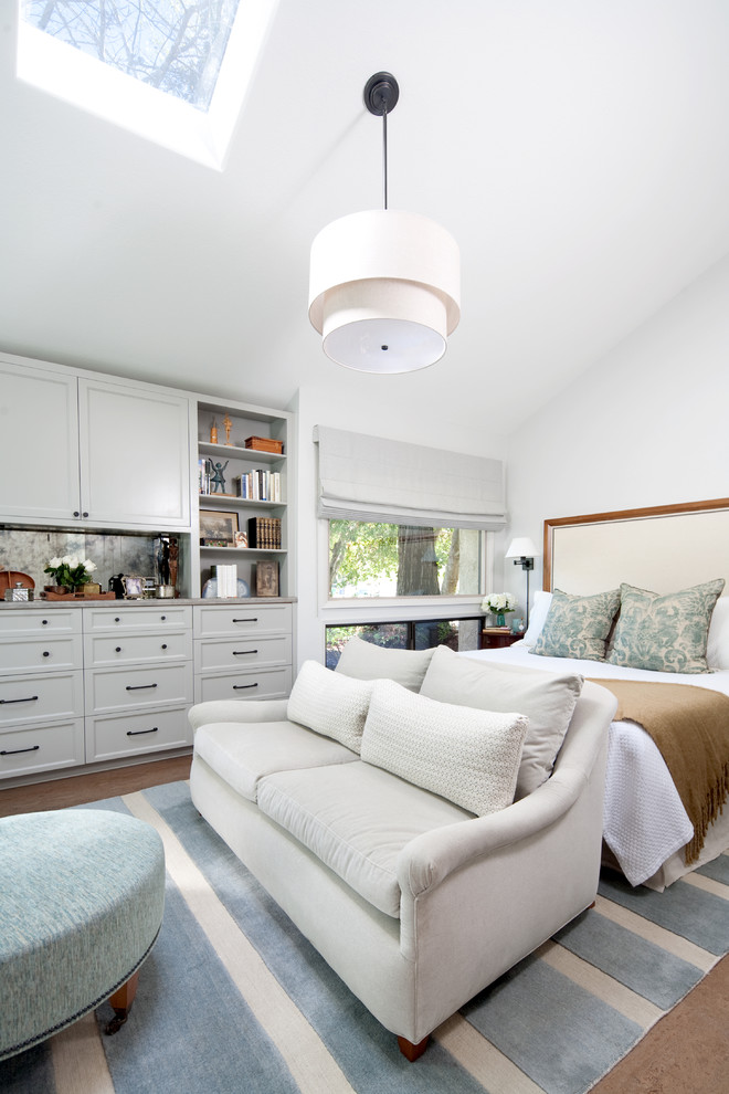 Photo of a large classic master bedroom in Santa Barbara with white walls.