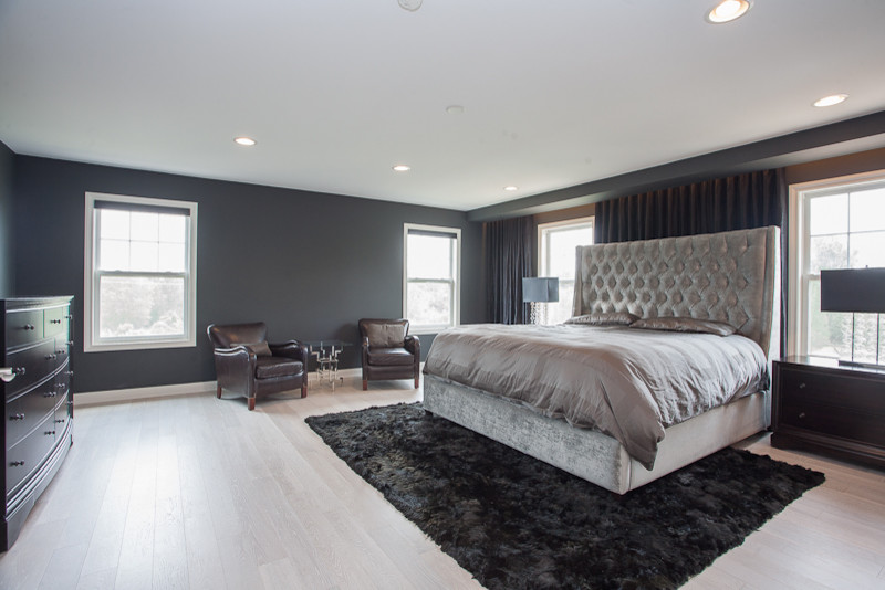 Large trendy master light wood floor bedroom photo in Chicago with gray walls and no fireplace