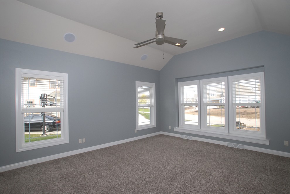 Large traditional master bedroom in Milwaukee with grey walls.