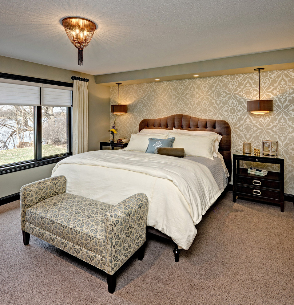Photo of a large traditional master bedroom in Minneapolis with beige walls and carpet.