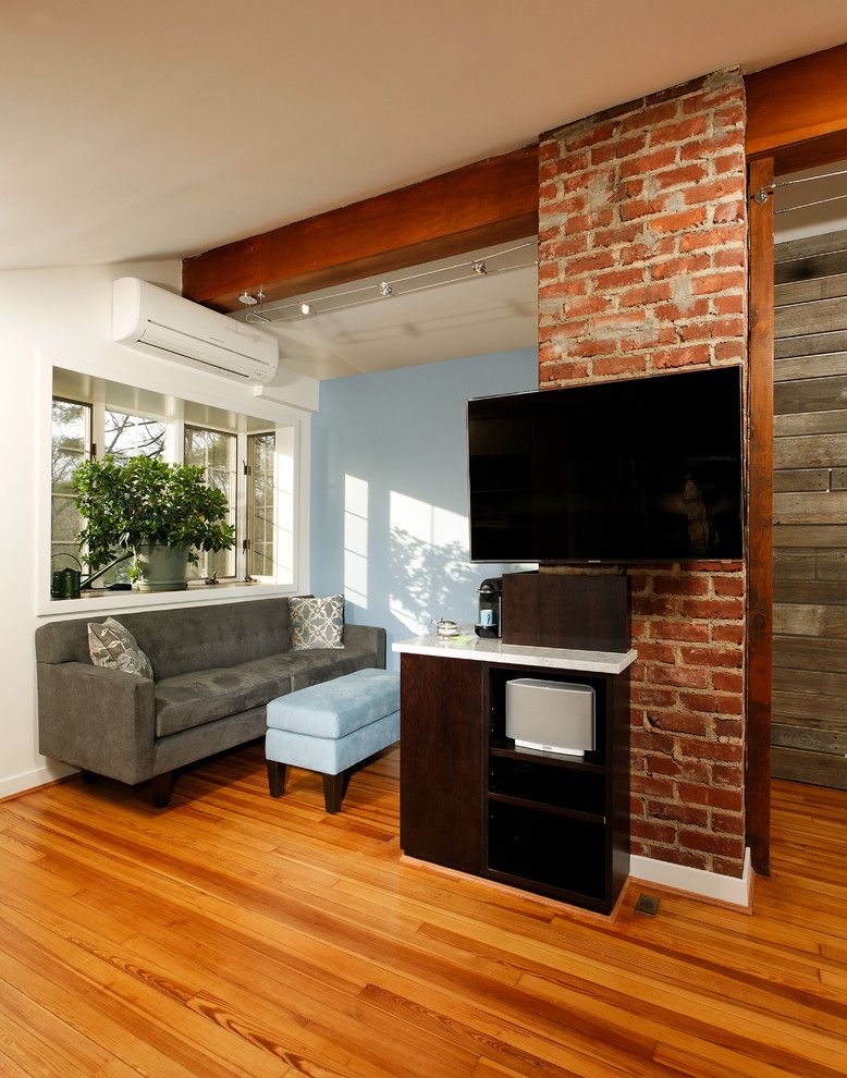 Diseño de dormitorio tipo loft clásico renovado pequeño con paredes azules, suelo de madera en tonos medios y chimenea lineal