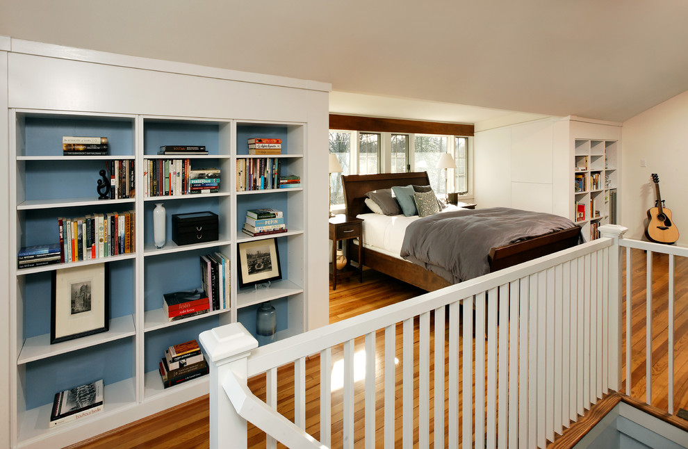 Design ideas for a large traditional mezzanine bedroom in DC Metro with white walls, medium hardwood flooring and no fireplace.