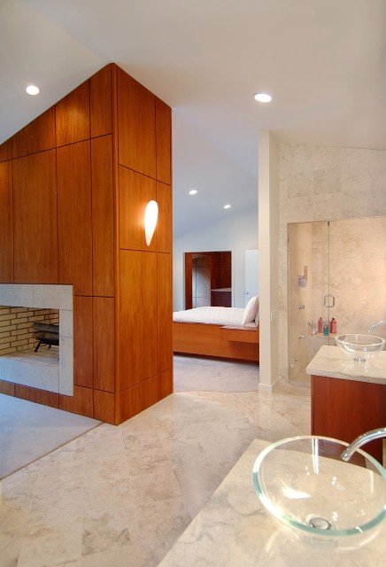 Bedroom - large master carpeted bedroom idea in New York with a two-sided fireplace and a tile fireplace