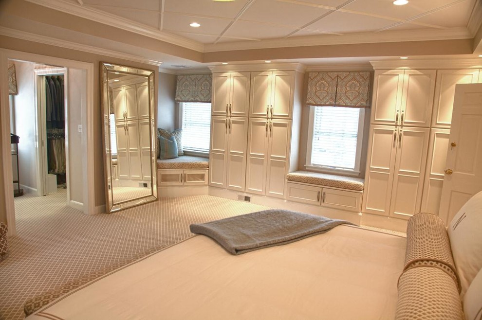 Example of a classic master carpeted bedroom design in Boston with beige walls